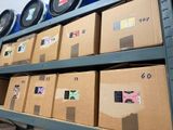 many boxes that are stacked on a shelf in a room