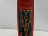 an old red book with a picture of a cat and a bird on it