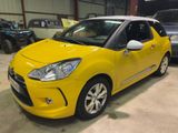 yellow citrole parked in a garage with other cars in the background