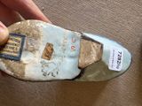a person holding a shoe that has a label on it