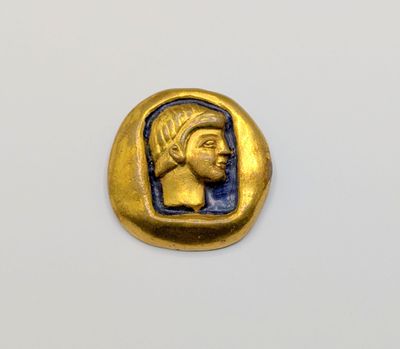 a gold and blue coin with a head of a woman