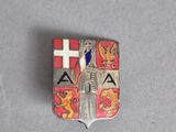 a close up of a metal badge with a red and white cross on it