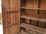 a large wooden cabinet with shelves and shelves in it