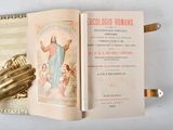 an open book with a picture of jesus on it and a gold glove