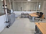 an image of an office with a lot of desks and chairs
