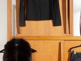 an image of a closet with a coat rack and a fur stoler