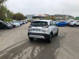 the silver car is parked in the parking lot next to other cars