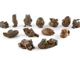 many small figurines of animals on a white surface