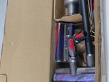 a box with a vacuum and other items inside of it