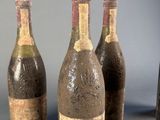 several bottles of wine are lined up on a table