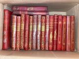 many books in a box on the shelf