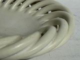 a close up of a white vase with a spiral design on it