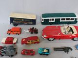 a lot of toy cars and trucks that are on a table