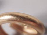 a close up of a gold ring on a table