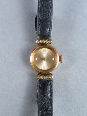 an image of a wrist watch with a gold dial