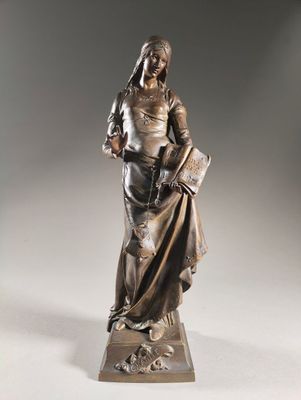 a bronze statue of a woman holding a book on a pedestal