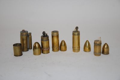 a lot of brass bullet shells on a white surface