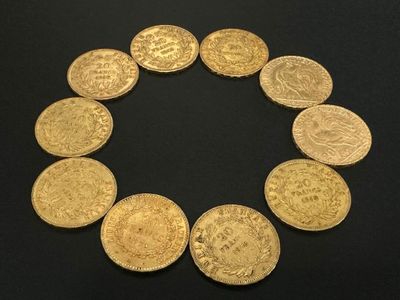 a close up of a circle of gold coins on a black surface