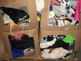 three cardboard boxes with clothes in them sitting on a pallet