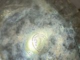 a silver plate with a silver lid sitting on a table