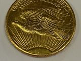 a gold coin with a eagle on it on a white surface