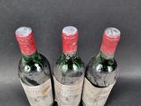 three bottles of wine sitting next to each other on a table