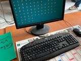 a desk with a keyboard, mouse, and monitor on it