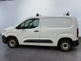 the white van is parked in the large room of the building