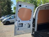 a white van with the door open in a parking lot