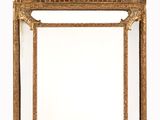 une image d'un miroir encadré d'or sur un fond blanc