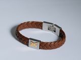 a brown leather bracelet with a silver clasp on a white surface