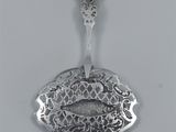 an image of a spoon with a fish on it sitting on a table