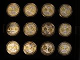 a lot of gold and silver coins in a display case