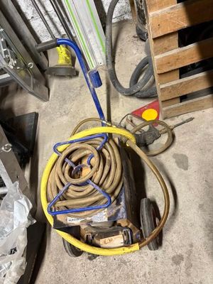 a hose that is sitting on a cart in the garage