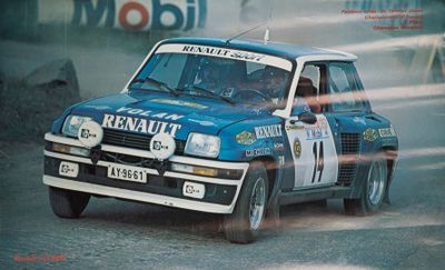 a blue truck driving down a dirt road with smoke coming out of it