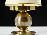 a lamp that is sitting on a table with a lamp shade on it