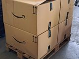 boxes stacked on a pallet in a warehouse with an amazon logo on them