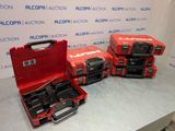 three red tool cases sitting on top of a table next to each other