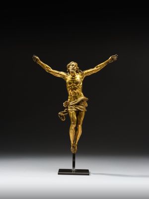 an image of a gold statue of jesus on a cross