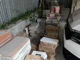 a car parked in a garage next to a pile of boxes