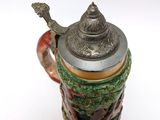 a close up of a beer mug on a white surface