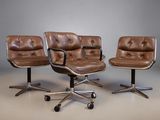 three brown leather office chairs sitting next to each other in a room