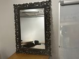 a mirror on the wall next to a desk