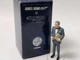 a figurine of a man in a suit standing next to a box of bond bond bond bond bond bond bond bond bond bond bond bond bond bond