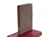 an image of a book on a wooden stand with a white background