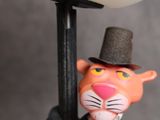 a figurine of a cat wearing a top hat and holding a lamp