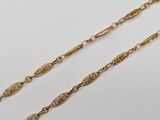 a pair of gold chain necklaces on a white background