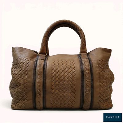 the large brown handbag is made of woven leather and has two zippers