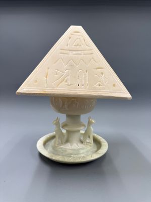 une image représentant un petit objet blanc surmonté d'une pyramide