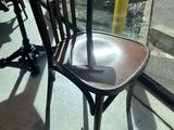 a wooden chair that is sitting in front of a window